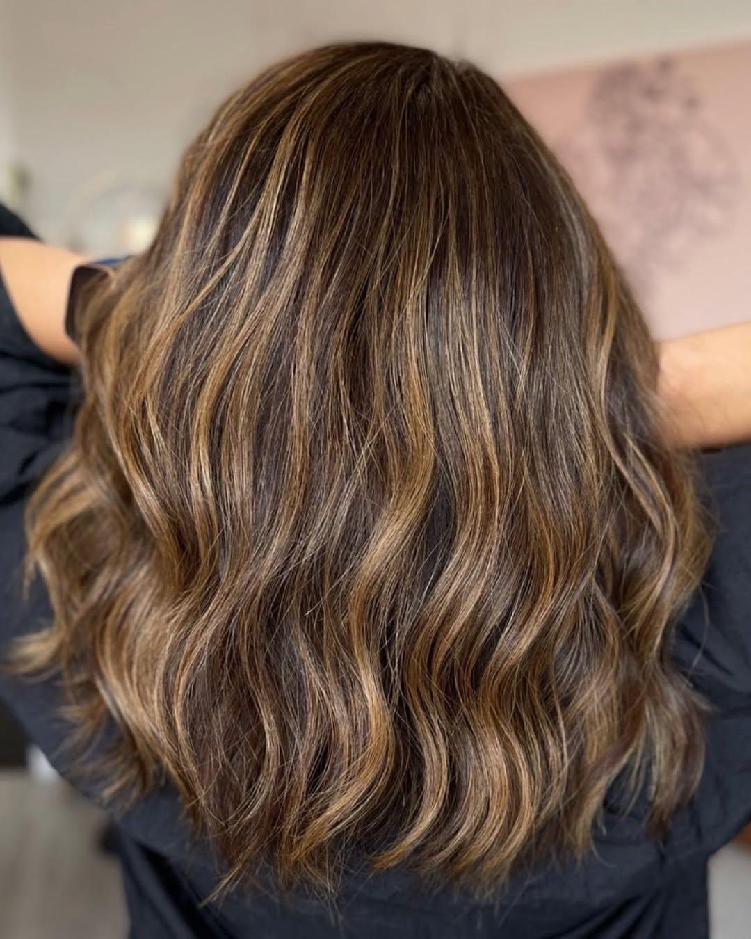 Long hair melting from a chocolate root to caramel ends