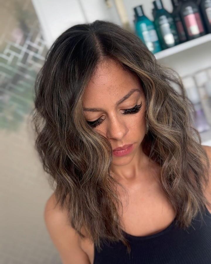 Warm caramel balayage blended softly through dark hair