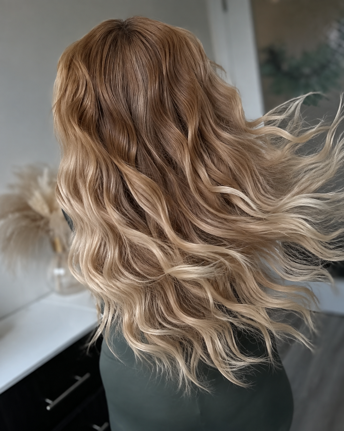 Long, full hair styled with hand-tied extensions